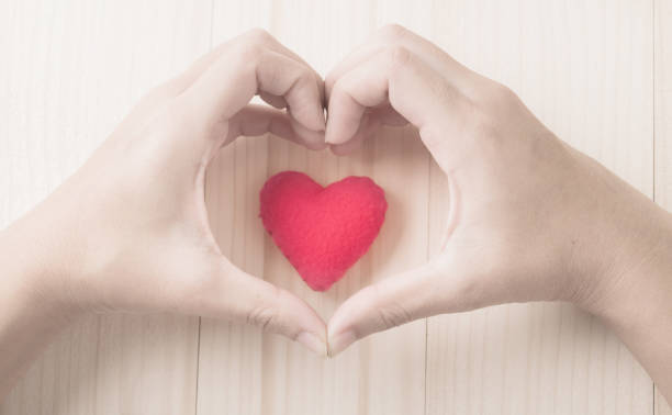 istock red heart in human hand with dramatic tone 931586896