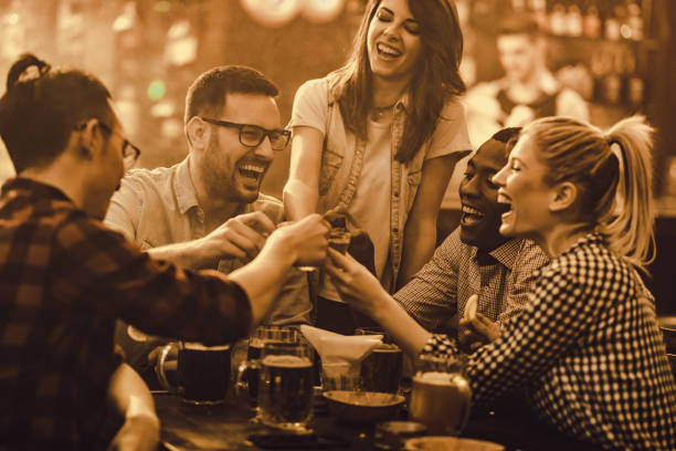istock Cheerful friends having fun while toasting with shots during their night out in a bar. 931588122