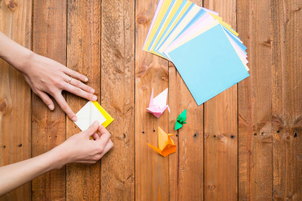 istock Women's hands to fold origami 931594886