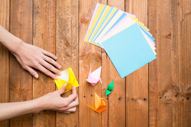 istock Women's hands to fold origami 931595014