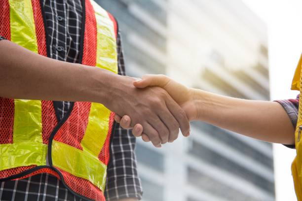 istock Engineers shake hands after success day and celebrate success. 931595096