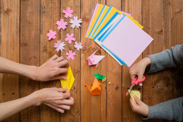istock Parent and child hand playing with origami 931595284