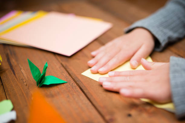 istock Children's hand playing with origami 931595520