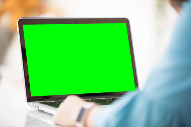 istock Mockup image of a woman using laptop with blank green screen. 931595534
