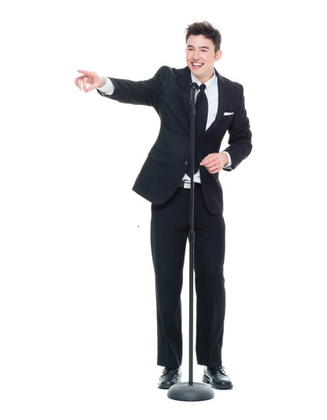 istock Good looking businessman speaking into a microphone and pointing 931595796