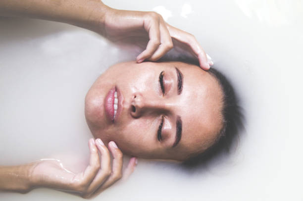 istock Attractive girl takes milk bath with milk. 931596144