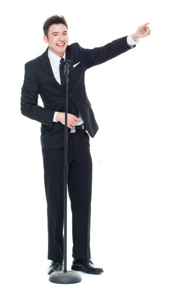 istock Good looking businessman speaking into a microphone and pointing 931596402
