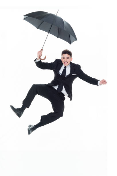 istock Businessman holding an umbrella and jumping 931597208
