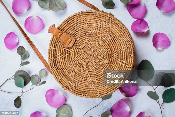 Fashionable Rattan Bag Flowers Rose Petals And Eucalyptus Leaves On Light Background Copy Space Top View Stock Photo - Download Image Now