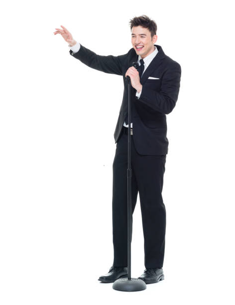 istock Good looking businessman speaking into a microphone and pointing 931599664