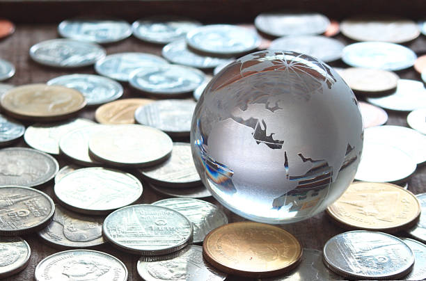 istock Map world glass on coins , finicial concept. 931599742