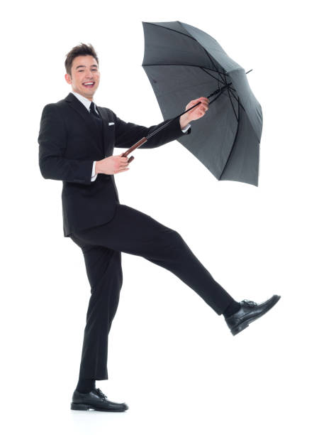 istock Handsome young businessman being silly with an umbrella 931600886