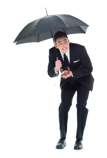 istock Businessman holding an umbrella and being scared 931601118