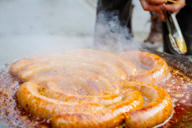 istock Baking delicious juicy sausages on barbecue plate 931604270