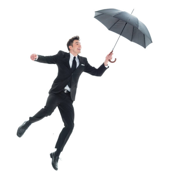 istock Handsome young businessman flying and jumping with umbrella 931604386