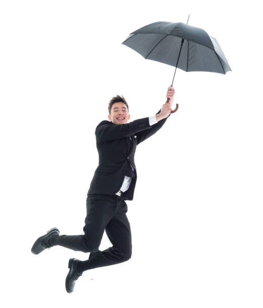 istock Handsome young businessman flying and jumping with umbrella 931605138