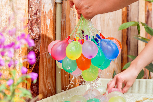 Filling colorful  water balloons with water