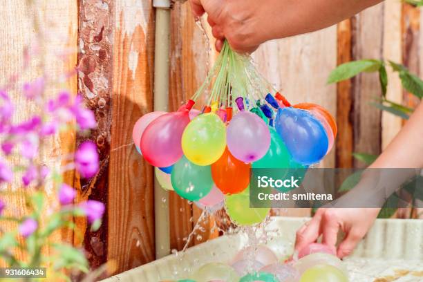 Filling Colorful Water Balloons With Water Stock Photo - Download Image Now - Water Bomb, Fighting, Water