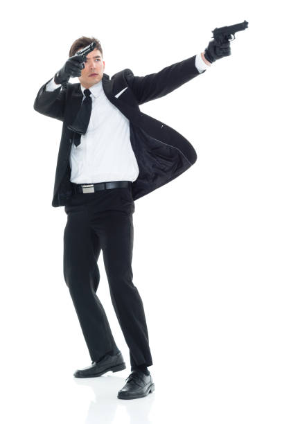 istock Assassin with handgun and firing 931606630