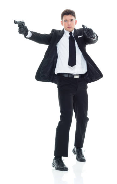 istock Assassin with handgun and firing 931611574