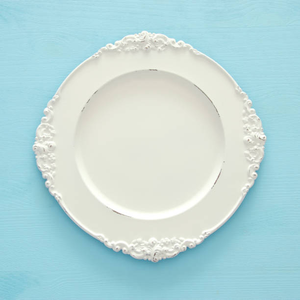 Top view of vintage white empty plate. Flat lay