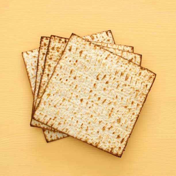 istock passover background with matzoh over yellow wooden background. 931613320