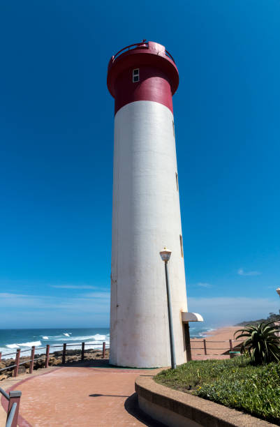 istock Portrait Red and White Lighthouse on Coastal Landscape 931617718