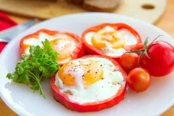 istock fried eggs in red peppers in a plate close-up. 931620934