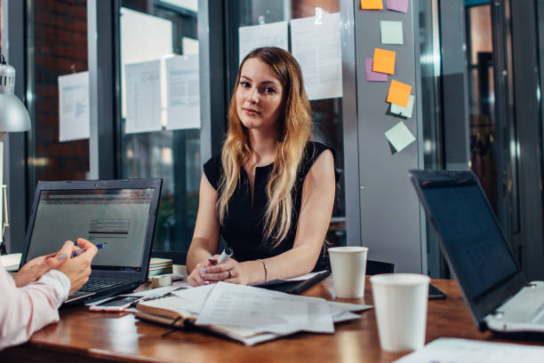 istock Smiling woman working sitting in modern office 931623510