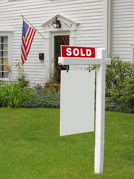 Photo of SOLD sign in front of mansion