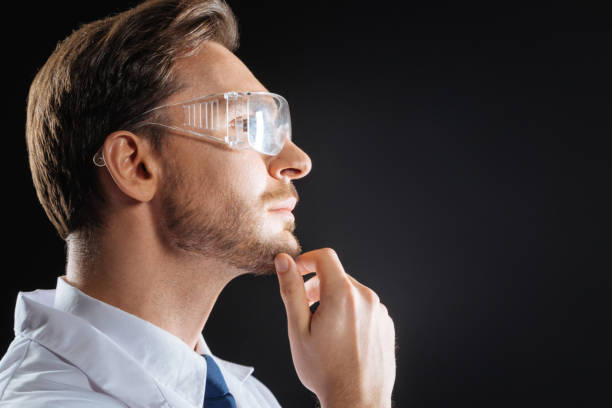 istock Thoughtful skilled scientist looking aside touching to his chin 931632194