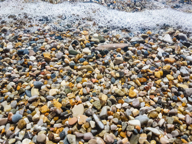 istock amazing blue sea view. calm waves hitting on pebble beach 931632726