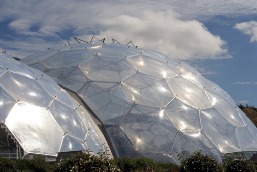 St Austell, Cornwall, United Kingdom:  April 13, 2016: Two of the biomes at the Eden Project. Inside the biomes, plants from many diverse climates and environments have been collected and are displayed to visitors. The Eden Project is located in a reclaimed Kaolinite pit, located about 5 kilometres from the town of St Austell, Cornwall in England.