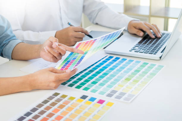 istock Midsection Of Business People Discussing Over Color Swatch While Working At Office 931636978