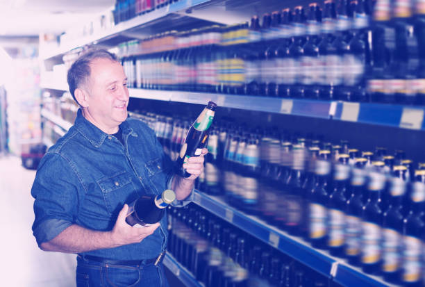 istock Glad pensioner selecting a beer at the store 931637076