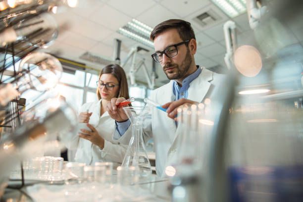 istock Young biochemists working with laboratory equipment during a scientific experiment. 931637334