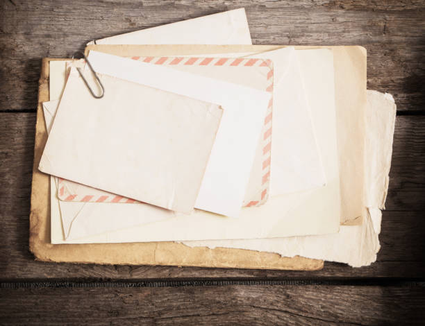 istock old paper on wooden background 931640096