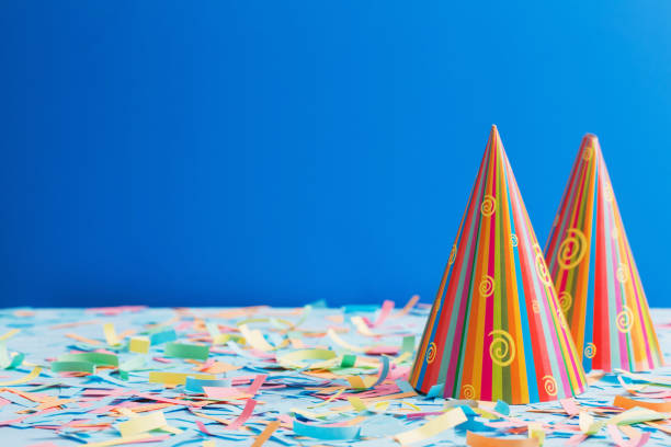 istock birthday hat and confetti  on blue background 931640174