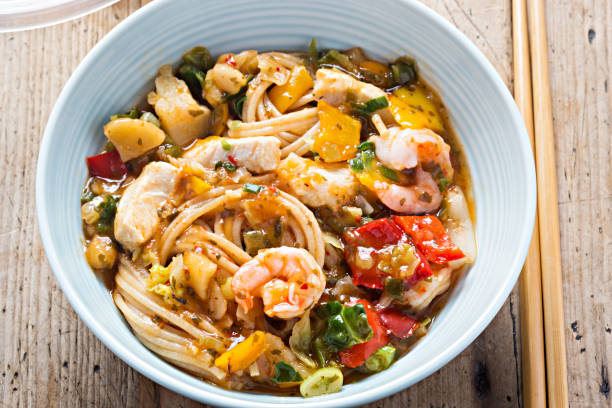 istock Spicy chicken & king prawn with wholewheat noodles 931644370