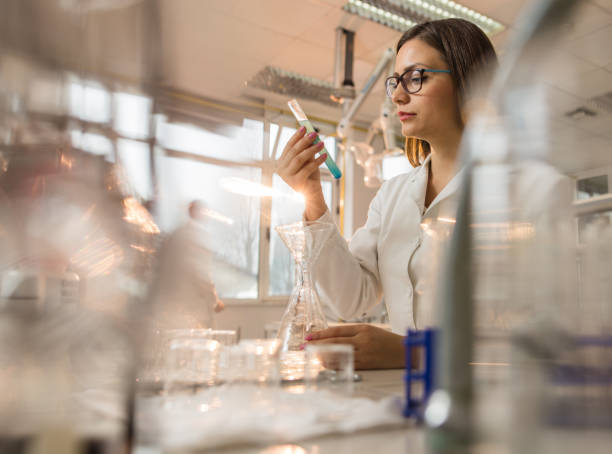 istock Young female biochemist working on scientific experiment in laboratory. 931644448