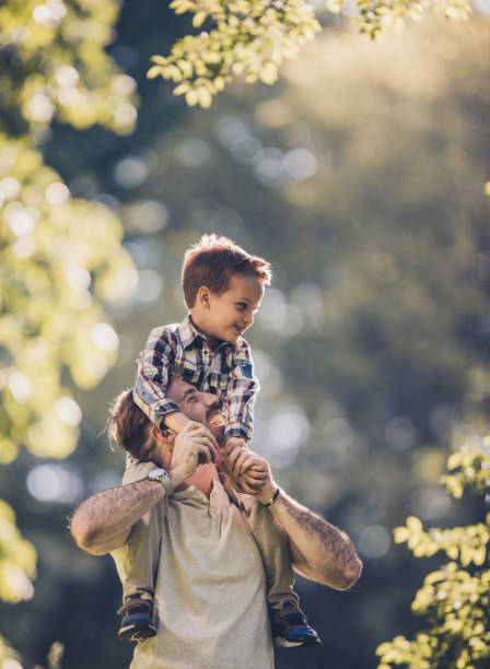 istock Cheerful father and son having fun in spring day outdoors. 931645080