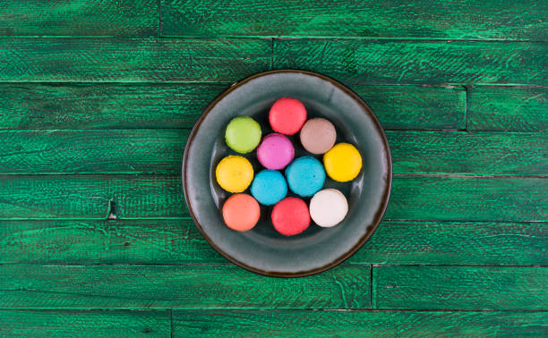 istock colorful french macarons ,green wooden table 931648406