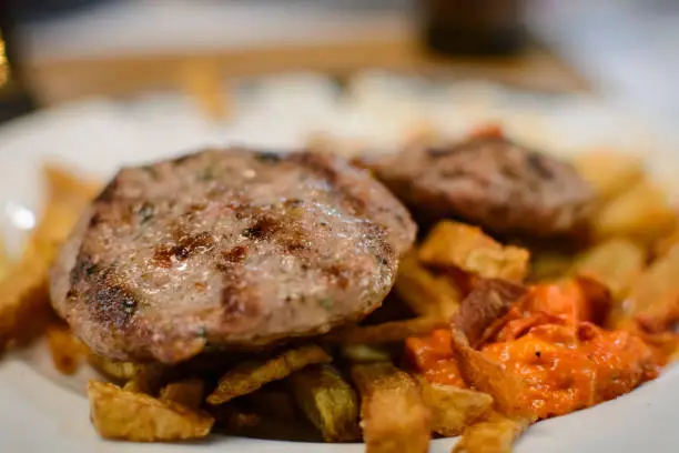 bulgaria traditional meat ball kufte with  french fries and lutenitsa
