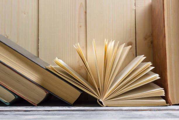 istock Open book, hardback books on wooden table. Back to school. Copy space 931649678