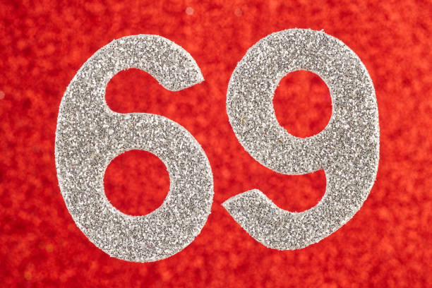 istock Number sixty-nine silver color over a red background. Anniversary. 931653240