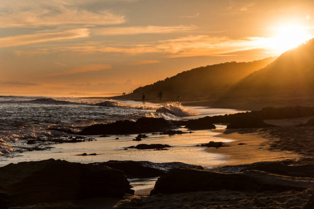 istock A bright sunset over hills leading to the beach 931653250