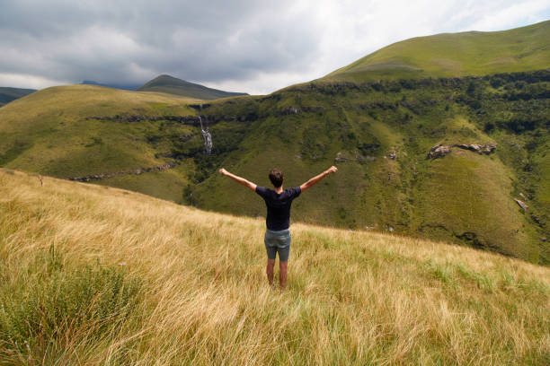istock Man with open arms during a hike in Drakensberg 931653714