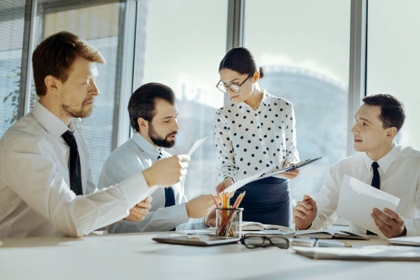 istock Pleasant secretary distributing copies of agreement to partners 931656472