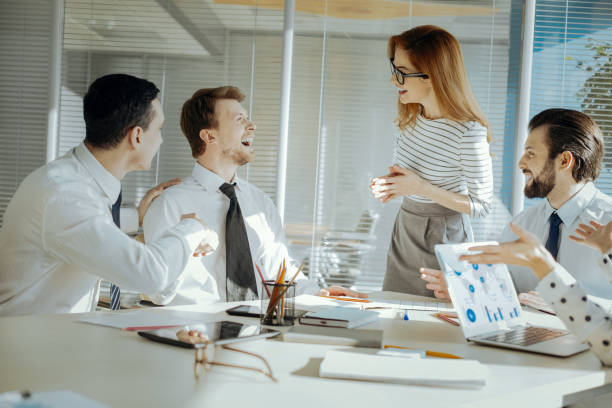 istock Upbeat team leader laughing together with her colleagues 931656726