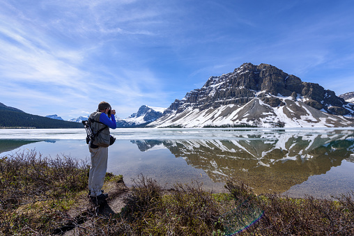 A Man Photographing Bow Lake, Alberta, Canada